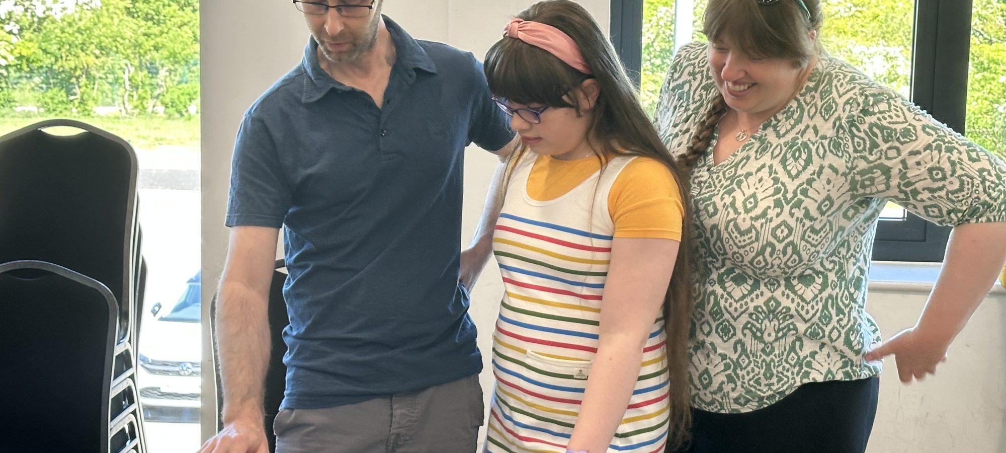 a family playing a piano at a creative health workshop